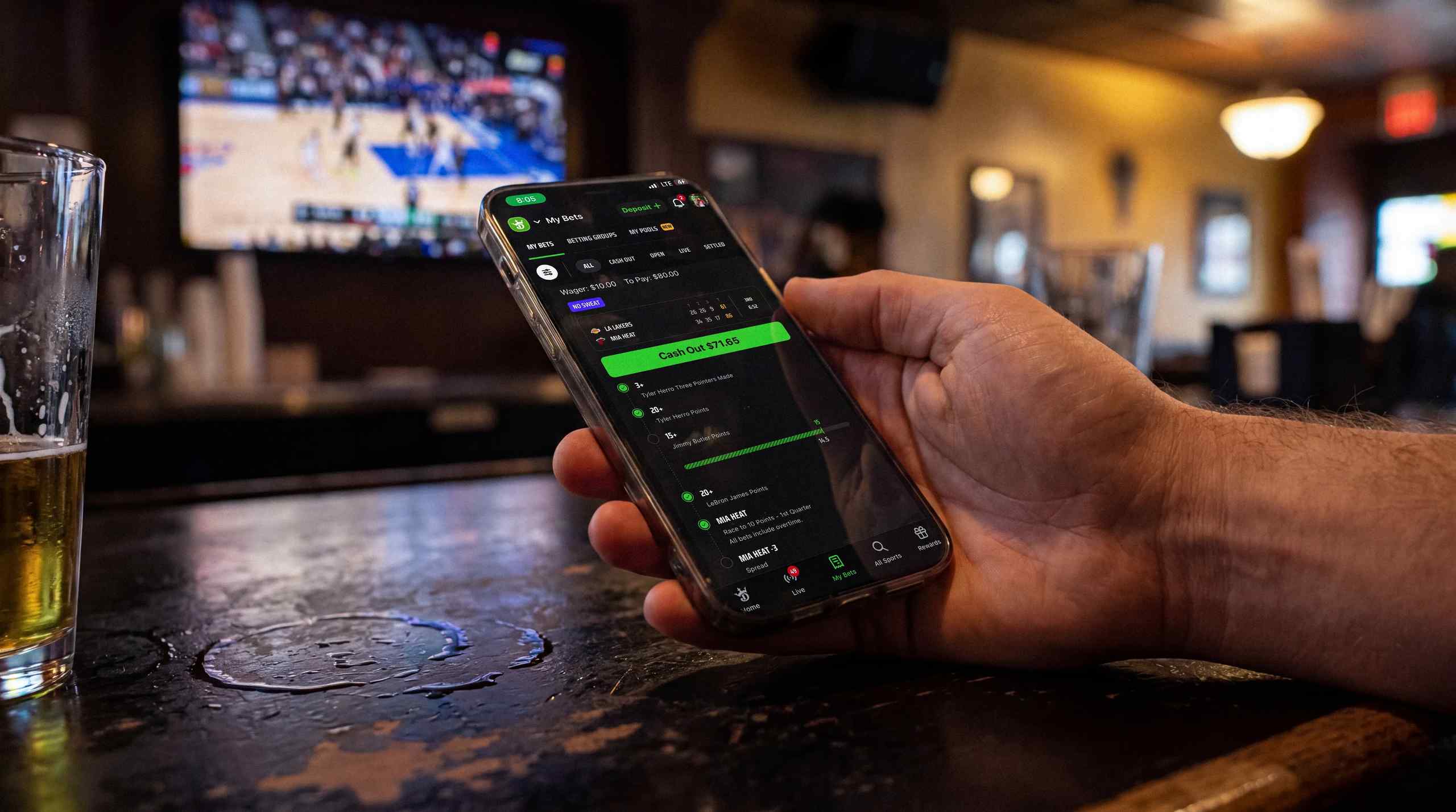A man using his phone to make a mobile bet.